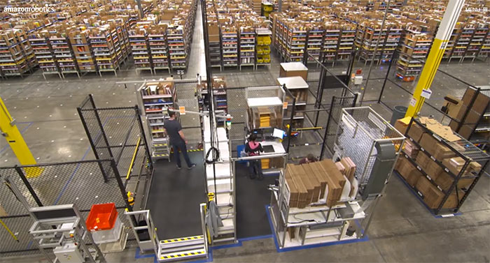 link to amazon robotics website image shows still frame of amazon fulfillment center with robotics